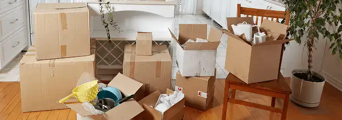 Packed moving boxes and household items in a kitchen before move-out or move-in cleaning, New Haven, CT.